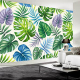 Papier peint feuilles tropicales vertes bleues et violettes